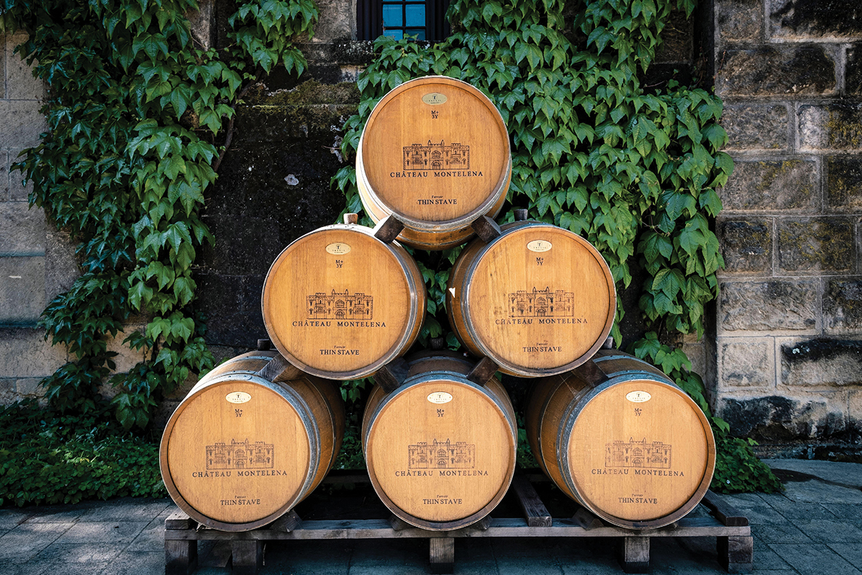 Stacked wine barrels in front of winery 